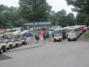 Golfers & Carts Preparing to Tee Off